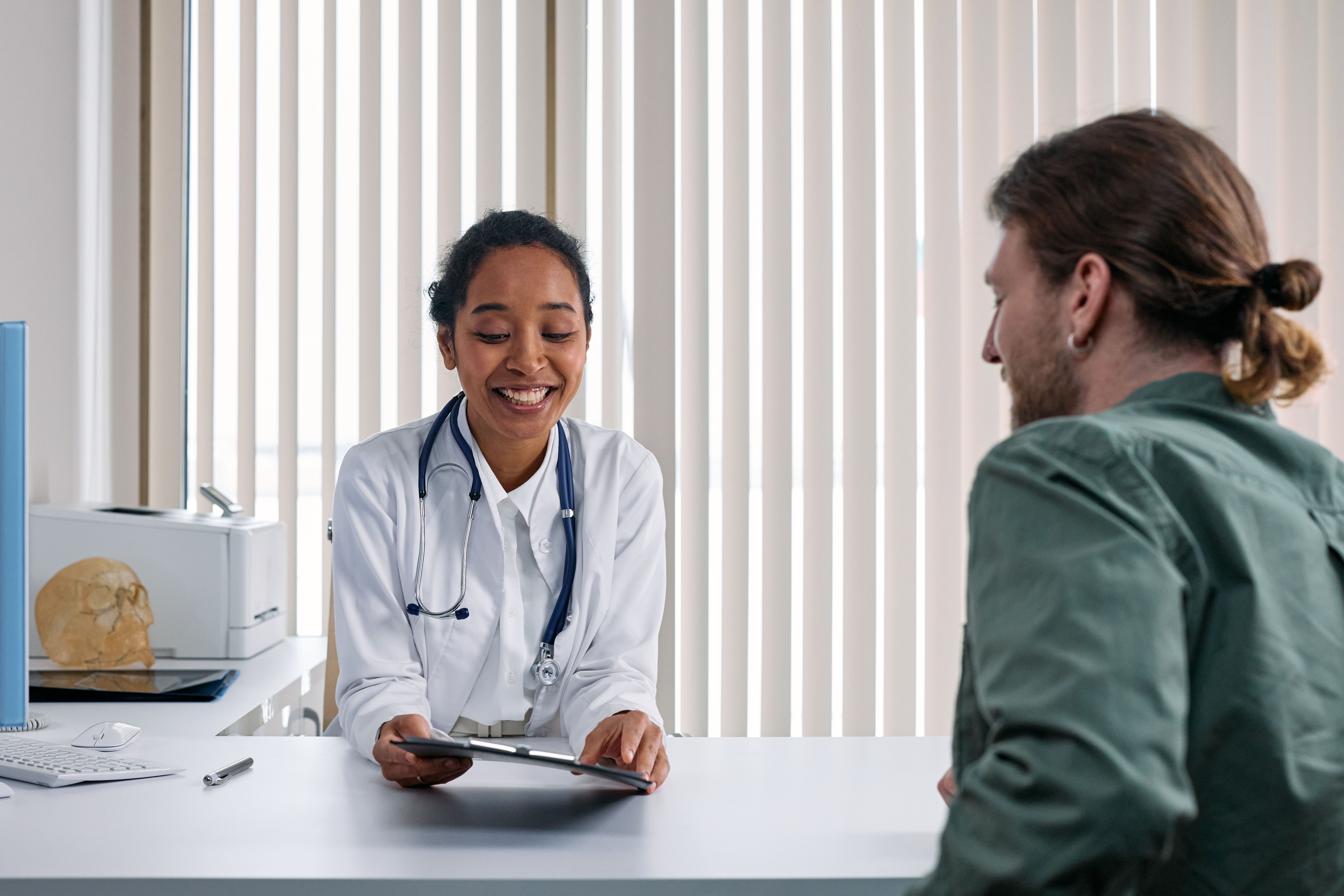 Doctor and patient engaged in a positive consultation in a bright modern clinic